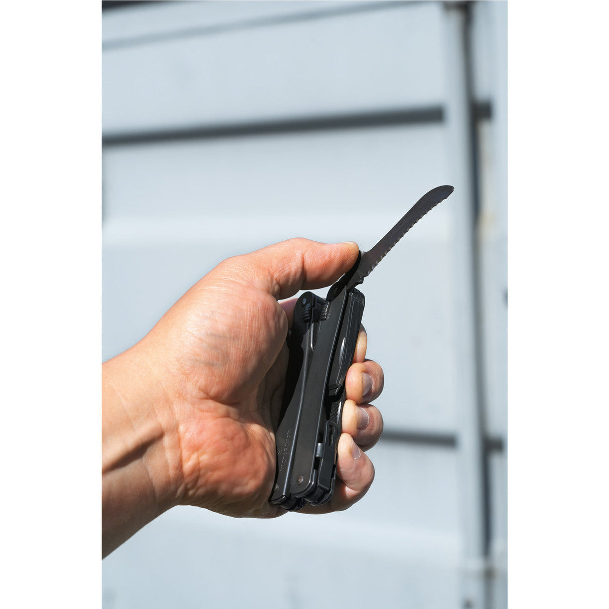 Folding pocket knife held in a hand.