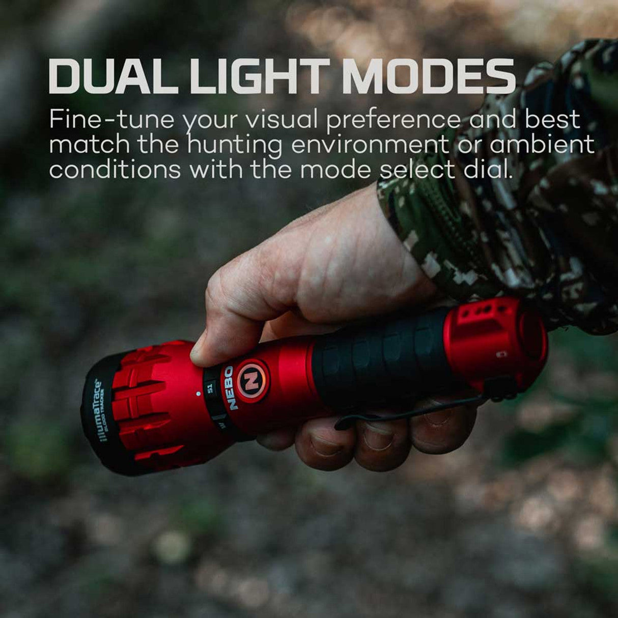 Red flashlight with dual light modes held in a hand wearing camouflage clothing.