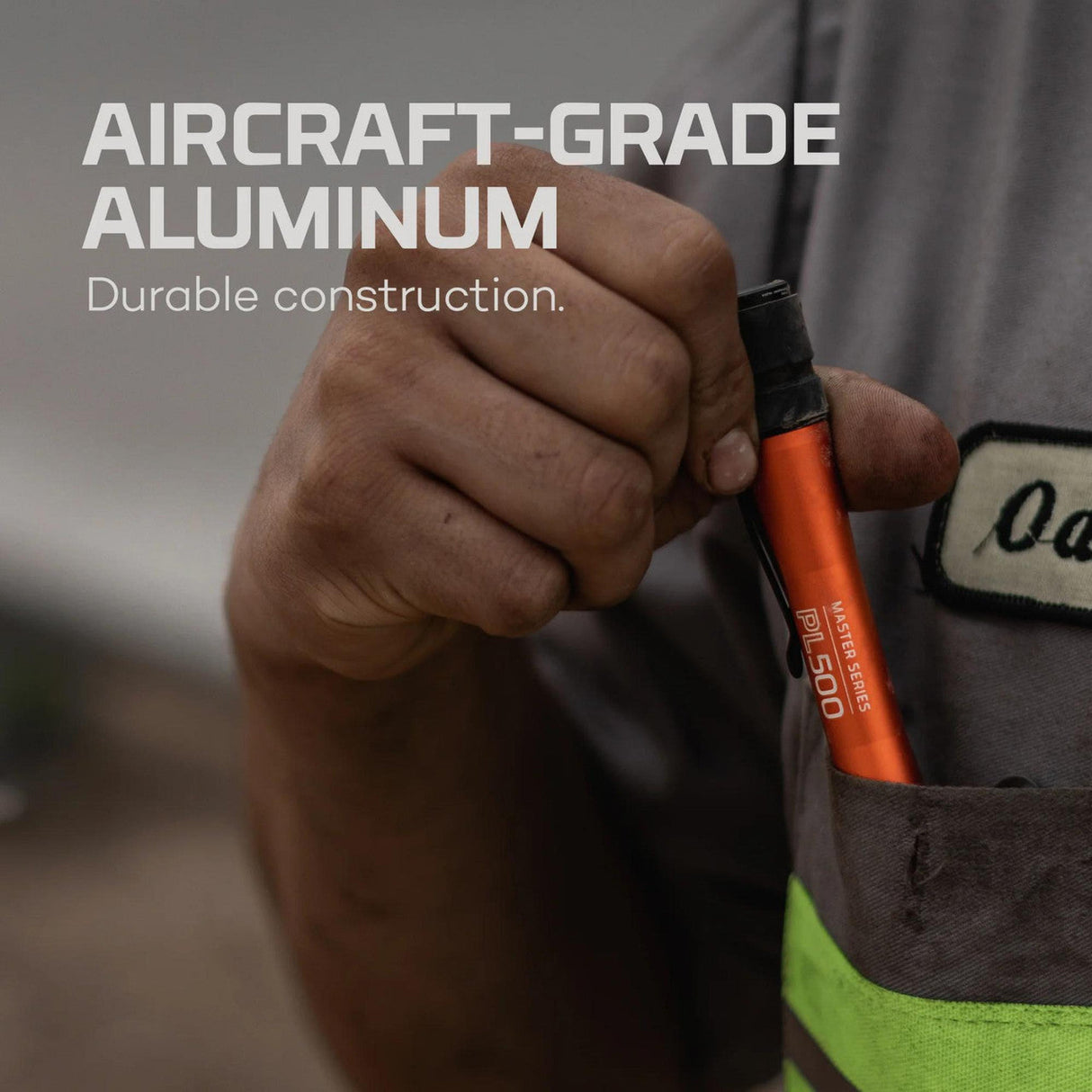 Orange and black handheld tool, likely a screwdriver or similar implement.