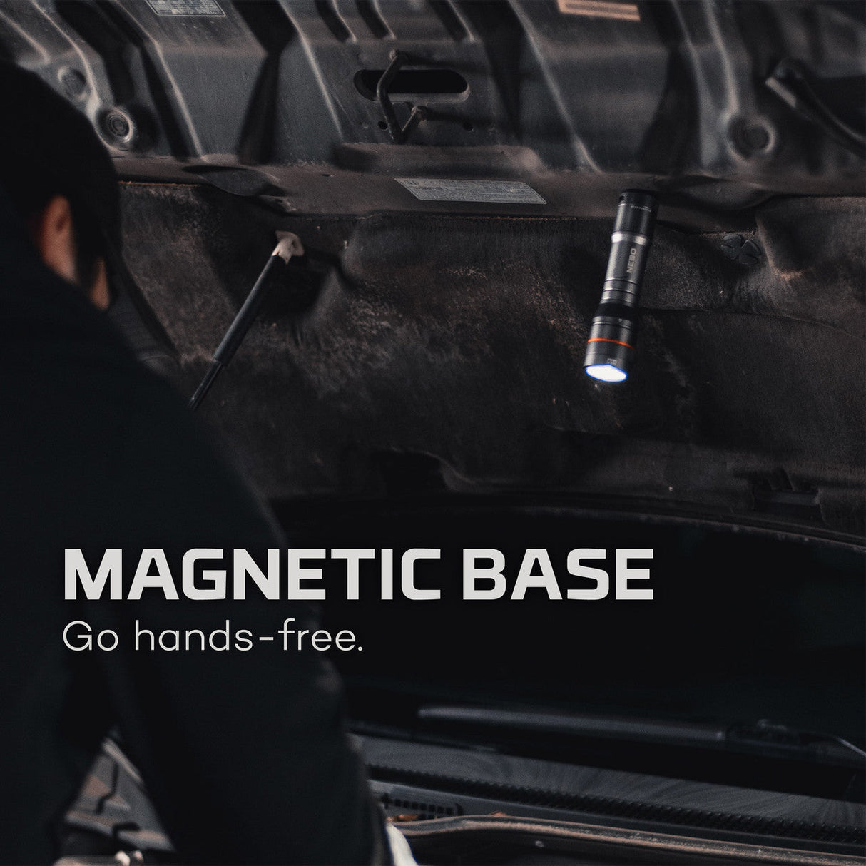 Magnetic flashlight attached to the underside of a vehicle.