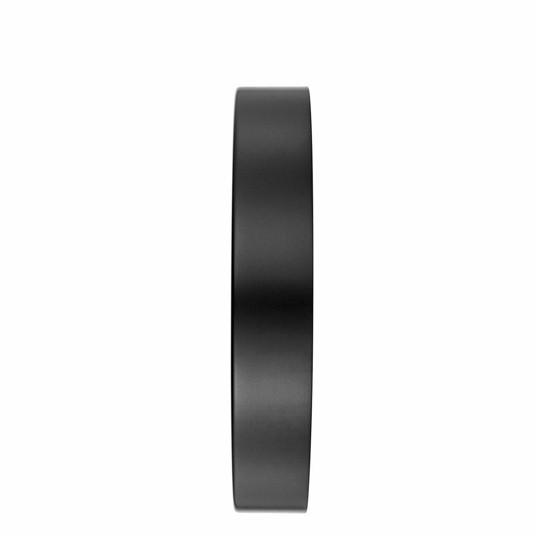Black circular disc or ring with a flat edge visible.
