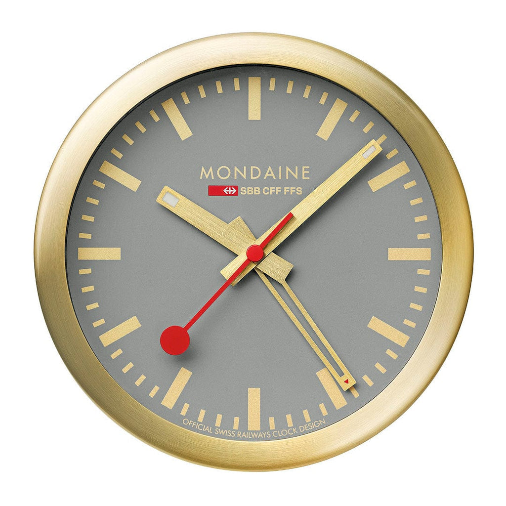 Gold-framed analog wall clock with a gray face and red hands.