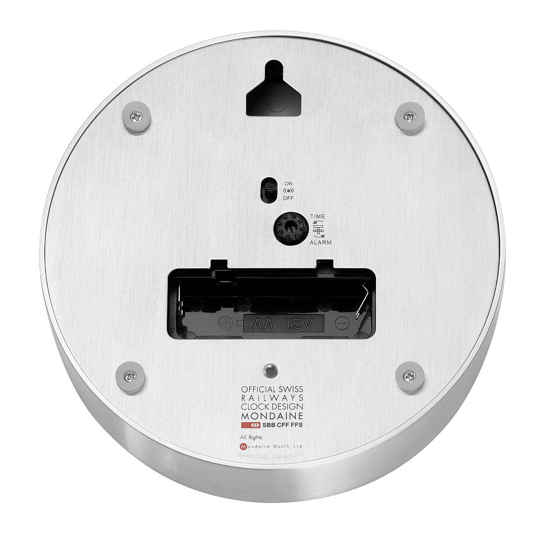 Circular white electronic device, likely a smoke detector or alarm, with visible mounting screws and a battery compartment.