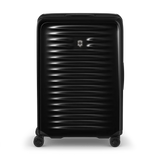 Black hardshell rolling suitcase with horizontal ridges and a Swiss Army logo.