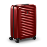 Red hardshell rolling suitcase with horizontal ridges and wheels.