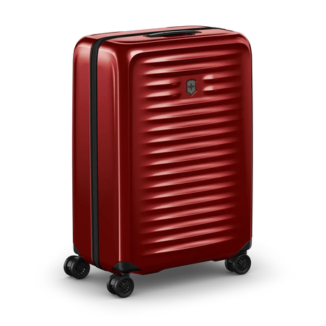 Red hardshell rolling suitcase with horizontal ridges and wheels.