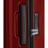 Red hardshell suitcase with a combination lock and zipper.