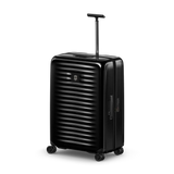 Black hard-shell rolling suitcase with horizontal ridges and an extendable handle.