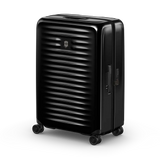 Black hardshell rolling suitcase with horizontal ridges on its surface.