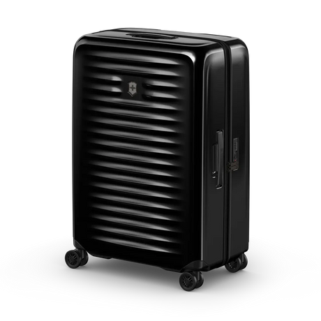 Black hardshell rolling suitcase with horizontal ridges on its surface.