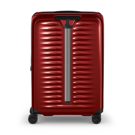 Red hardshell rolling suitcase with horizontal ridges and a telescoping handle.