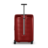 Red hardshell rolling suitcase with horizontal ridges and an extendable handle.