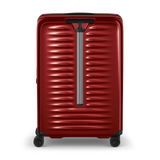Red hardshell rolling suitcase with horizontal ridges and a vertical handle.