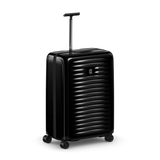Black hardshell rolling suitcase with horizontal ridges and an extendable handle.