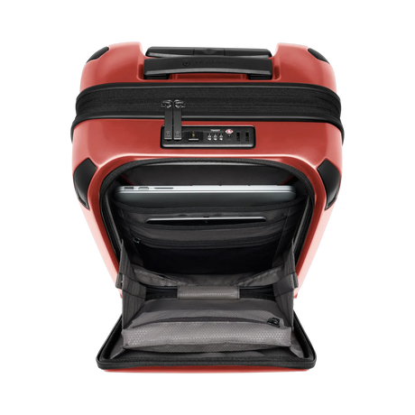 Red hardshell suitcase with an open front compartment and a combination lock.