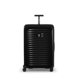 Black hardshell rolling suitcase with horizontal ribbed texture and extendable handle.