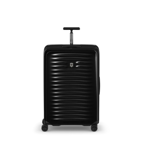 Black hardshell rolling suitcase with horizontal ribbed texture and extendable handle.
