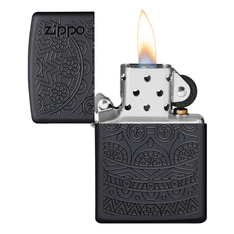 Zippo lighter with intricate engraved patterns on a black matte finish, shown open with a flame.