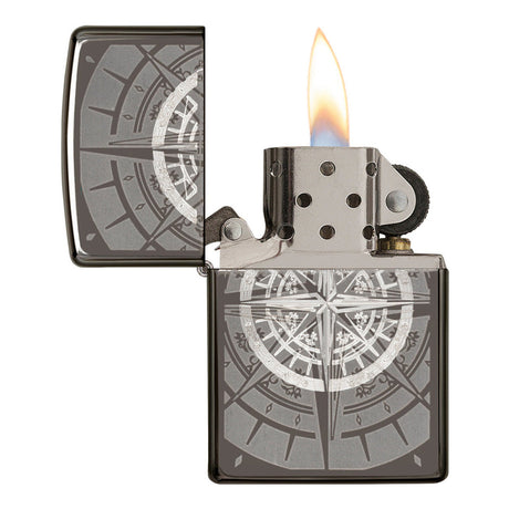 Metal lighter with an engraved compass rose design and a lit flame.