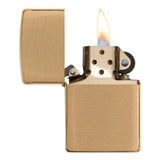 Gold-colored metal lighter with an open lid and visible flame.