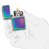 Iridescent metal lighter with a lit flame.