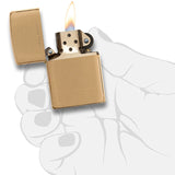Gold-colored metal lighter with an open flame.