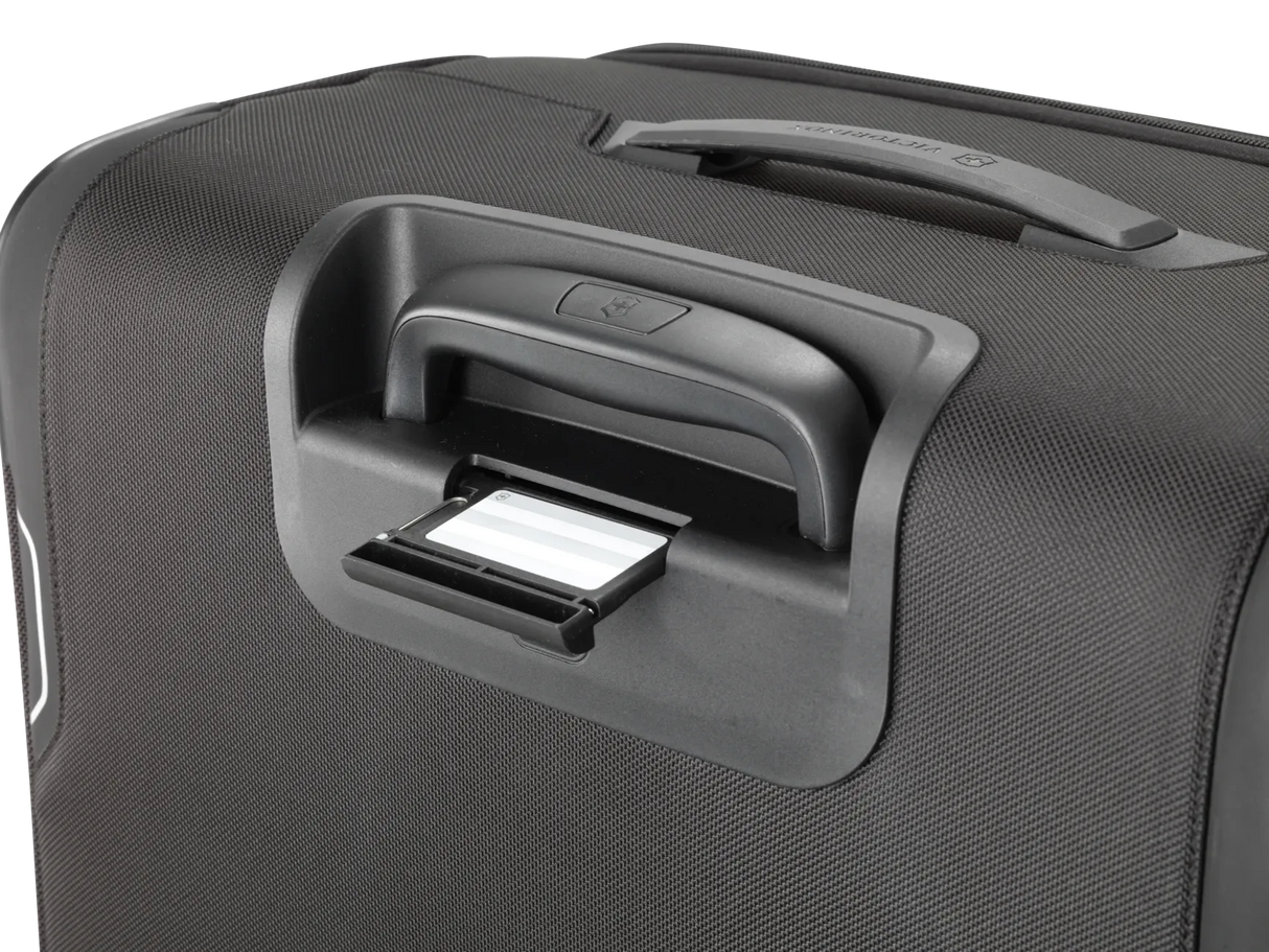 Suitcase handle with an integrated luggage tag slot.