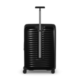 Black hard-shell rolling suitcase with horizontal ridges and an extendable handle.