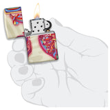 Lit Zippo-style lighter with colorful floral design on its case.