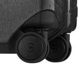 Luggage wheels attached to the bottom corner of a suitcase.
