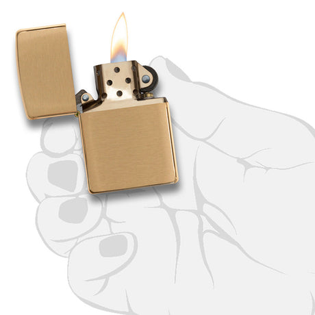 Gold-colored Zippo lighter with a lit flame.
