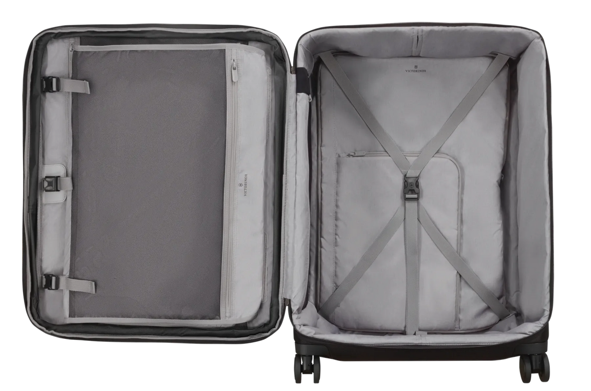 Open suitcase with compartments and straps for organizing belongings.
