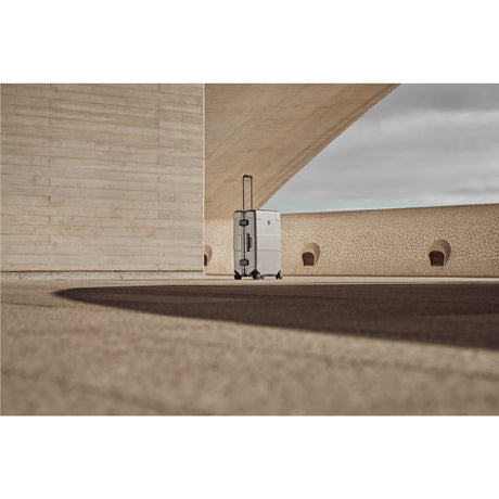Metallic suitcase or luggage standing alone on a smooth floor.
