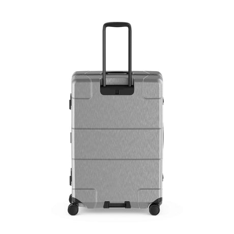 Gray hard-shell rolling suitcase with an extendable handle and wheels.