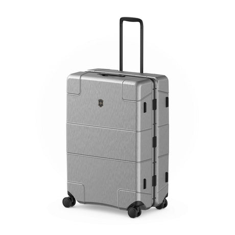 Silver hardshell rolling suitcase with a retractable handle and wheels.