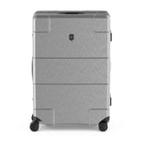 Silver hardshell rolling suitcase with horizontal ridges and a logo emblem.