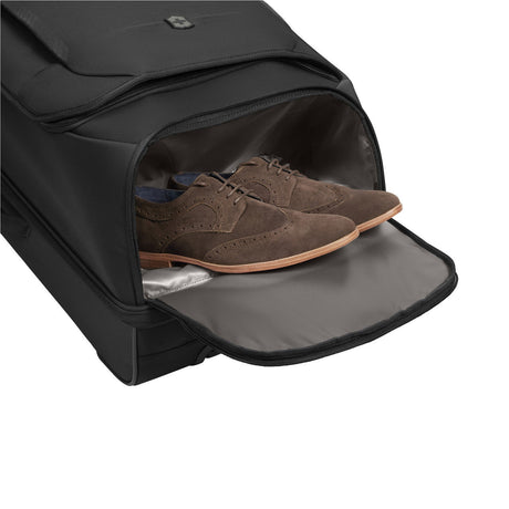 Black travel bag with a compartment for shoes, showing a brown leather brogue inside.
