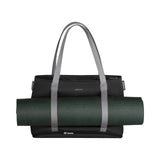 Black tote bag with gray handles carrying a rolled-up yoga mat.