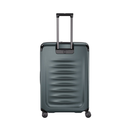 Gray hardshell rolling suitcase with telescoping handle and horizontal ridges on the front.