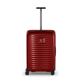 Red hardshell rolling suitcase with horizontal ridges and an extendable handle.