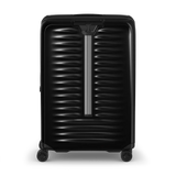 Black hardshell rolling suitcase with horizontal ridges and a telescoping handle.