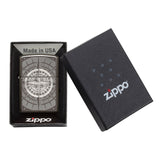 Zippo lighter with a compass design engraved on its surface, displayed in its packaging.