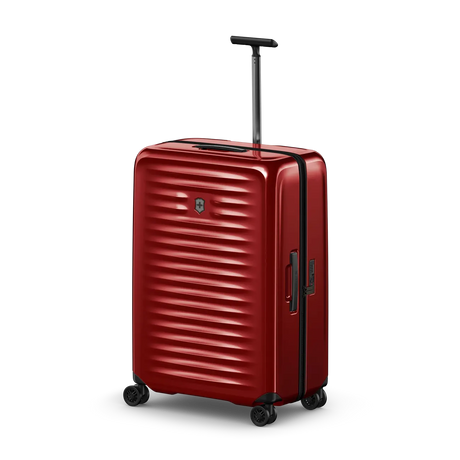 Red hardshell rolling suitcase with horizontal ridges and a retractable handle.