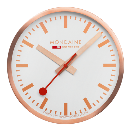 Circular wall clock with a rose gold frame and white face displaying the Mondaine brand.