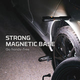 Flashlight with a magnetic base attached to a vehicle’s wheel or tire.