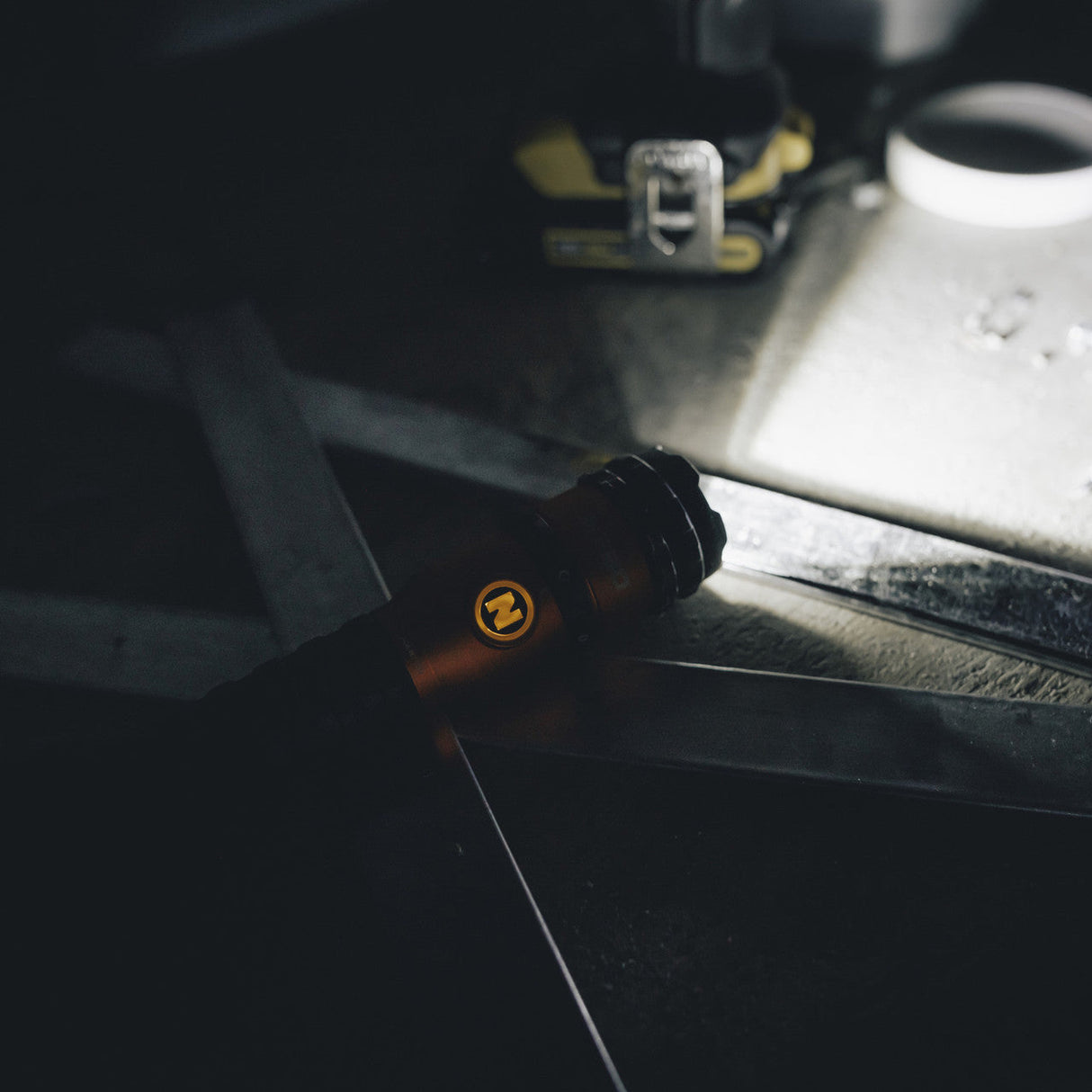 Packaged flashlight or handheld torch in orange and blue retail boxes.