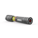 Handheld flashlight with a gray metallic body and a colorful band near the lens.