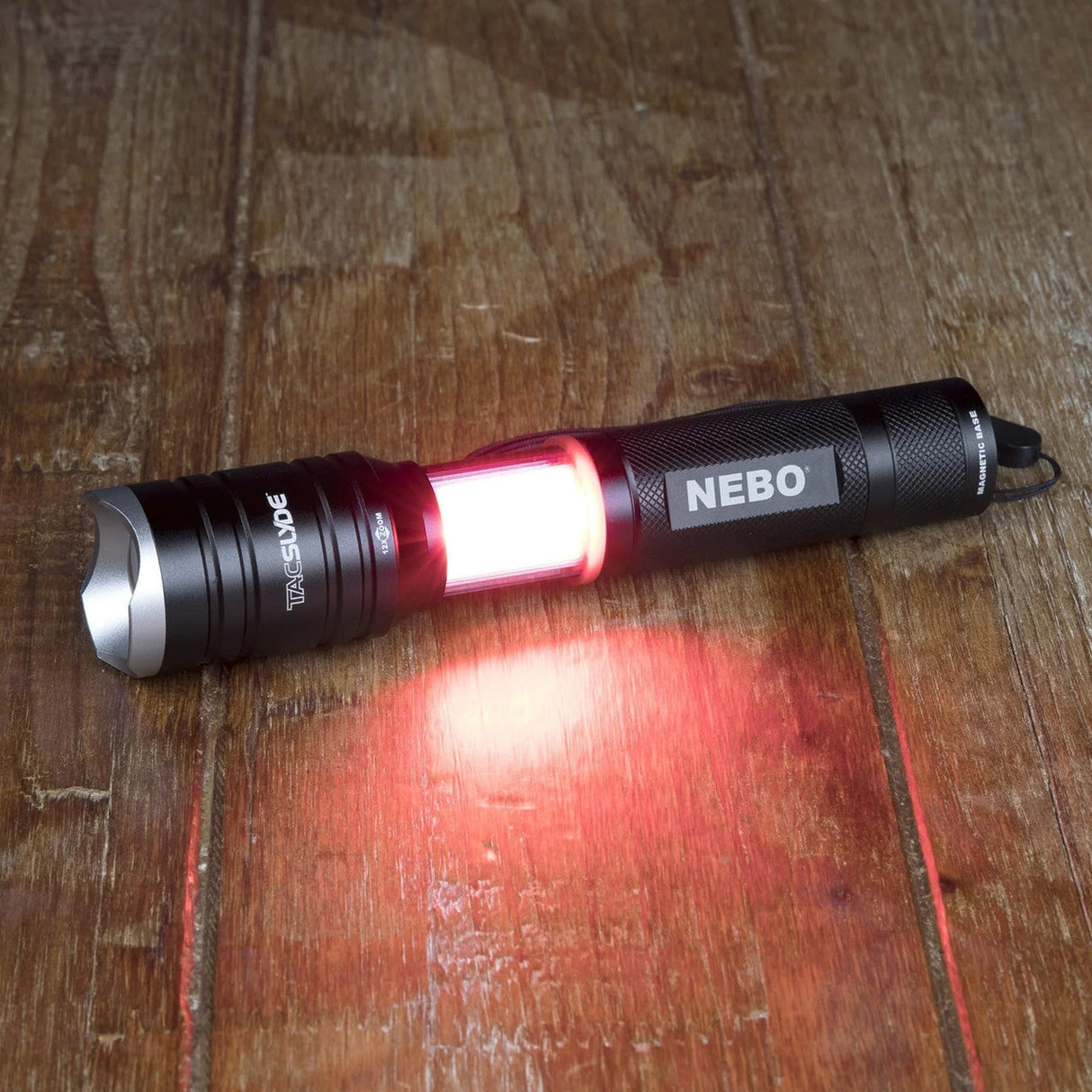Flashlight with a red illuminated section and ’NEBO’ branding.