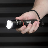 Handheld flashlight labeled ’NEBO’ being gripped by a person’s hand.