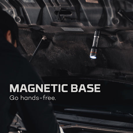 Magnetic flashlight attached to the underside of a vehicle.